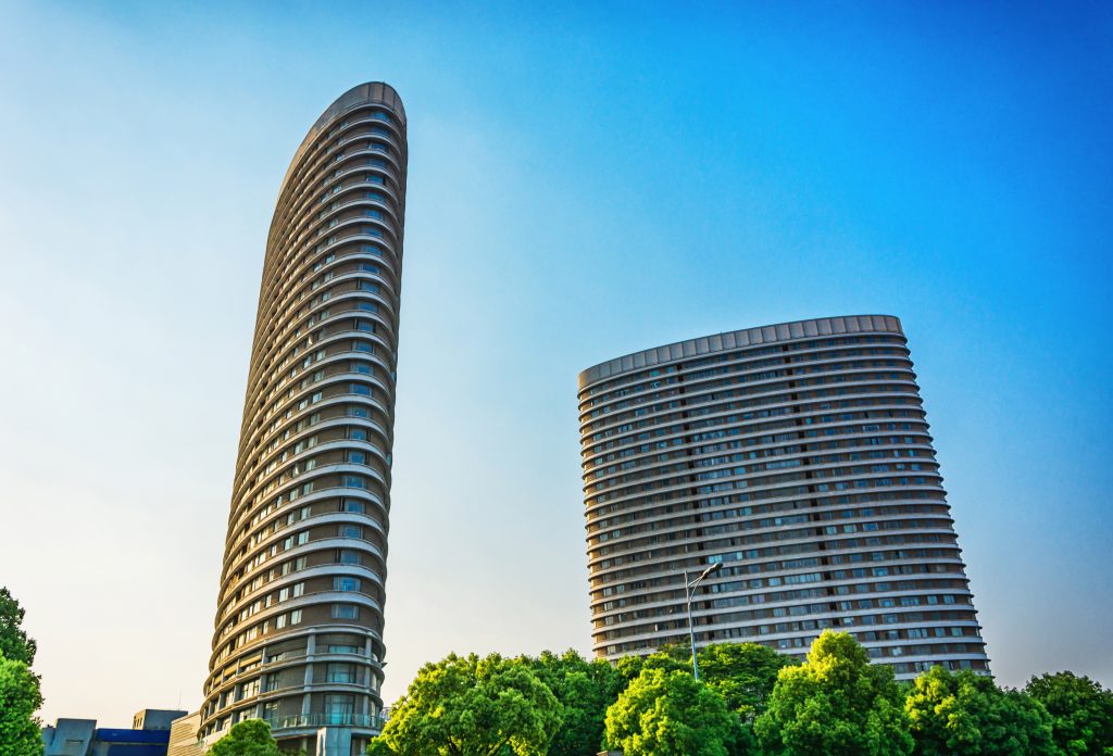 Two tall office buildings and trees